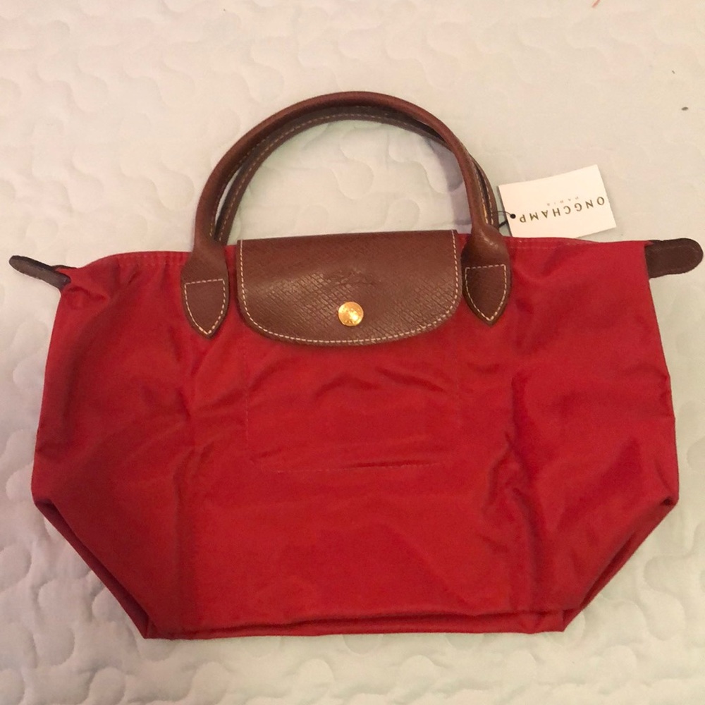 Small red longchamp bag.